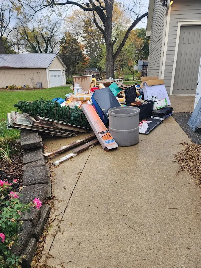 Dumpster being loaded with debris for Estate Cleanout Dumpster Rental in Epsom